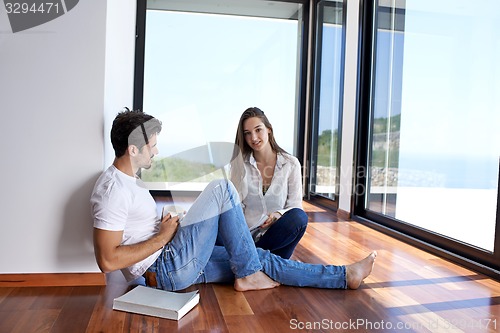 Image of relaxed young couple at home staircase