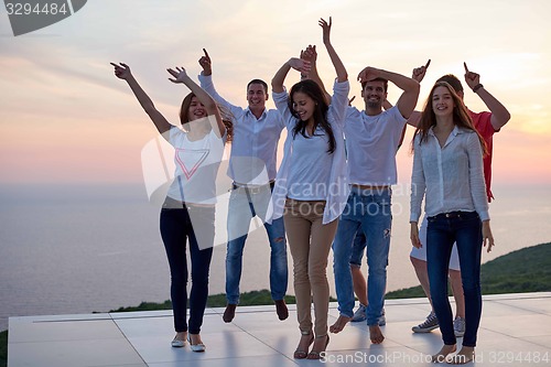 Image of party people  on sunset