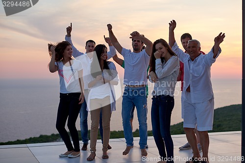 Image of party people  on sunset