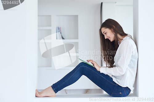 Image of woman at home using tablet