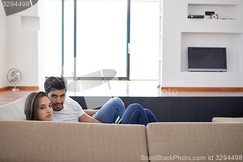 Image of relaxed young couple at home staircase