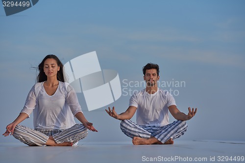 Image of young couple practicing yoga