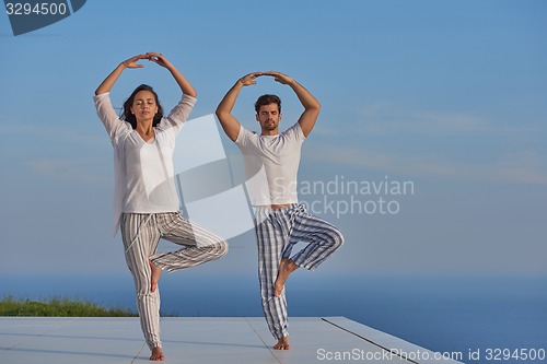 Image of young couple practicing yoga