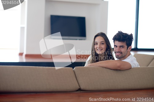 Image of relaxed young couple at home staircase