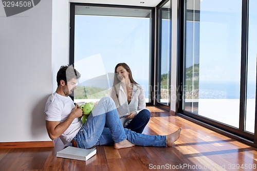 Image of relaxed young couple at home staircase