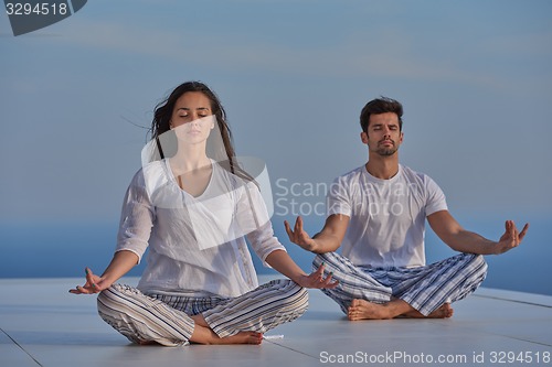 Image of young couple practicing yoga