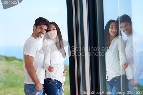 Image of relaxed young couple at home staircase