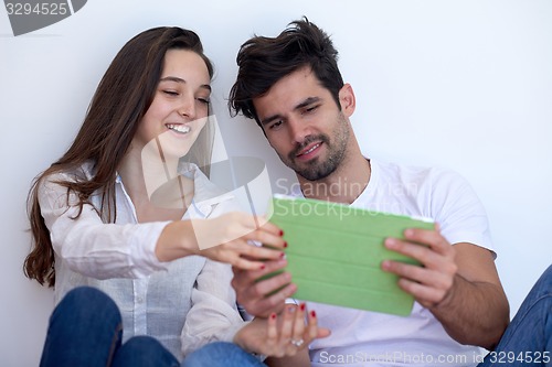 Image of couple at modern home using tablet computer
