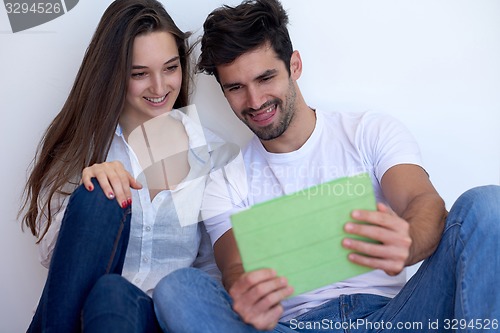 Image of couple at modern home using tablet computer