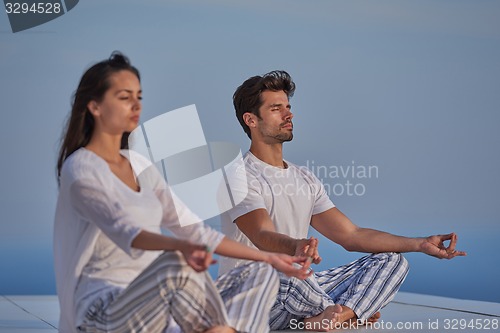Image of young couple practicing yoga