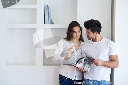 Image of relaxed young couple at home staircase