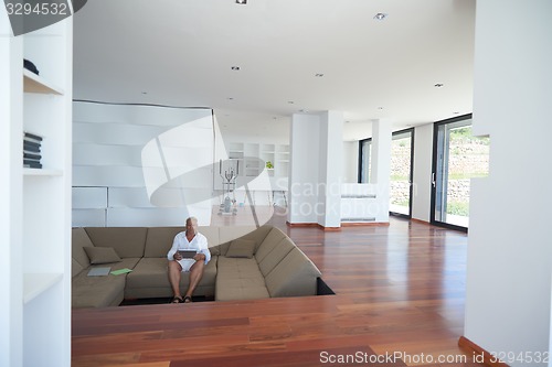 Image of Portrait of senior man relaxing in sofa