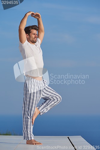 Image of young man practicing yoga