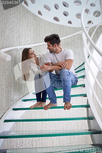 Image of relaxed yung couple at home  stairs