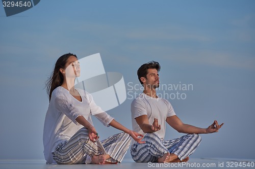 Image of young couple practicing yoga