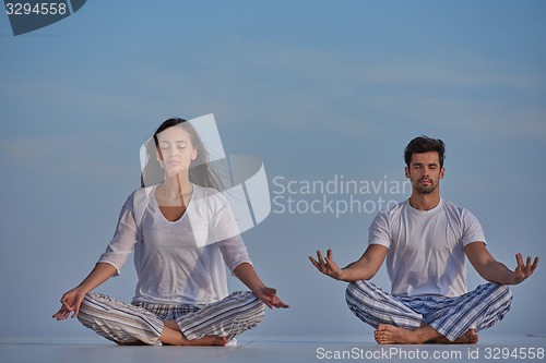 Image of young couple practicing yoga