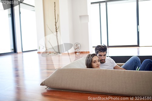 Image of relaxed young couple at home staircase