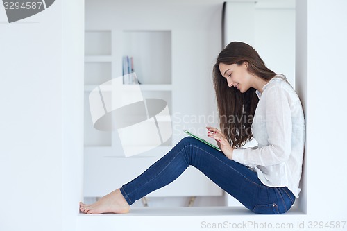 Image of woman at home using tablet