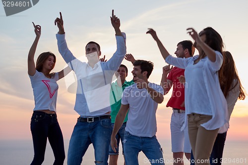 Image of party people  on sunset