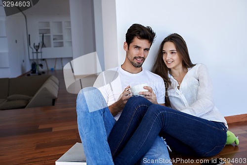 Image of relaxed young couple at home staircase