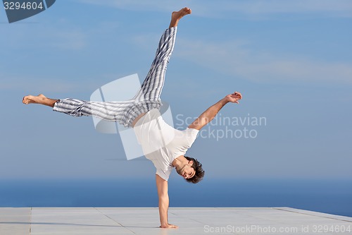 Image of young man practicing yoga