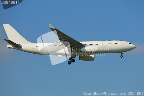 Image of Plane landing against clear blue sky