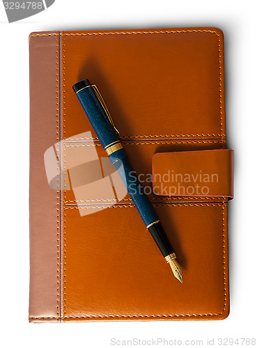 Image of Fountain pen on top of the closed notebook top view