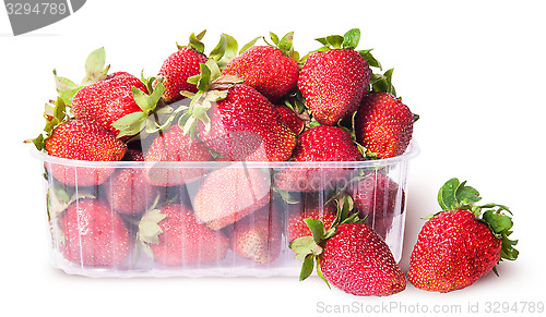 Image of Freshly strawberries in a plastic tray and two near