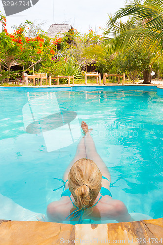 Image of Caucasian lady floating in swimming pool.