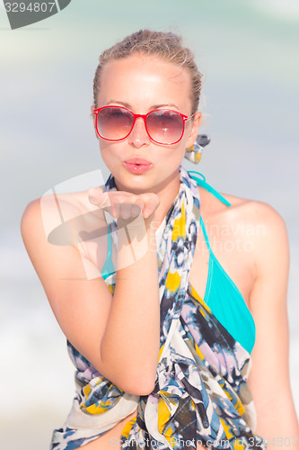 Image of Woman sending a kiss from summer vacations.