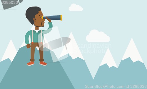 Image of Black man on top of blue mountain.