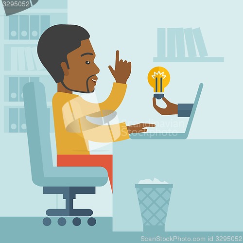 Image of Black guy working inside his office.