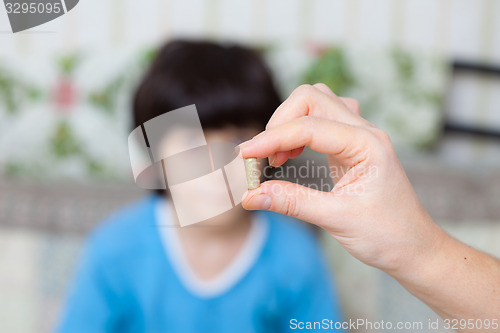 Image of doctor with pill and boy