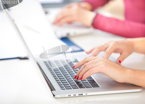 Image of woman typing on laptop