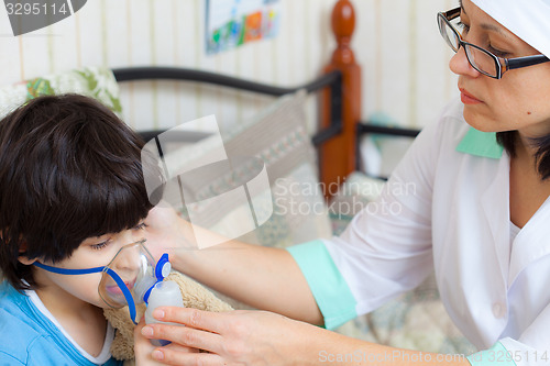 Image of doctor pediatrician spends boy inhalation