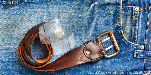 Image of vintage belt on old blue jeans