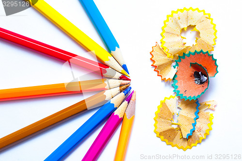 Image of seven colored pencils and shavings