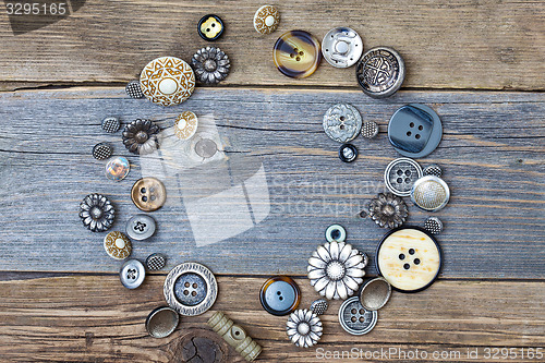 Image of several old buttons on the vintage table surface