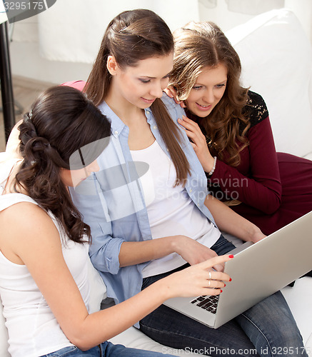 Image of Three students and a notebook