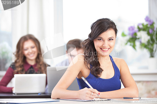 Image of girl with pen at classroom