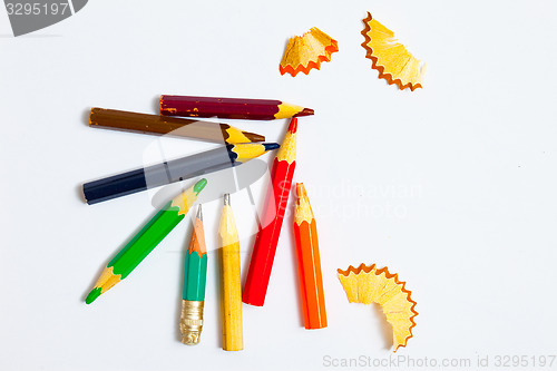 Image of several vintage pencils and shavings on a white