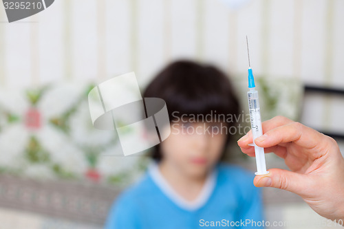 Image of Doctor hand with syringe and boy