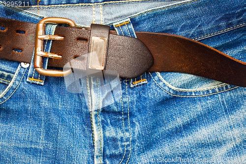 Image of leather belt on old jeans