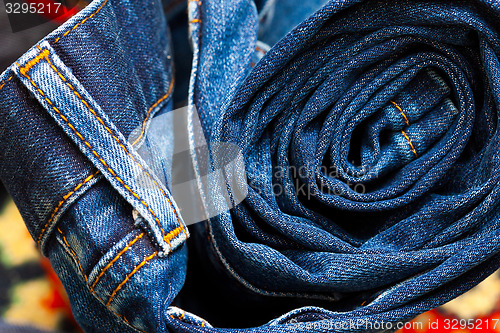 Image of jeans constricted into a roll