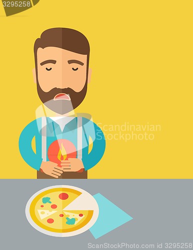 Image of Man has a stomach burn or abdominal pain after he ate pizza.