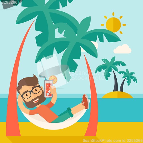 Image of Young man on th beach relaxing and drinking cocktail.