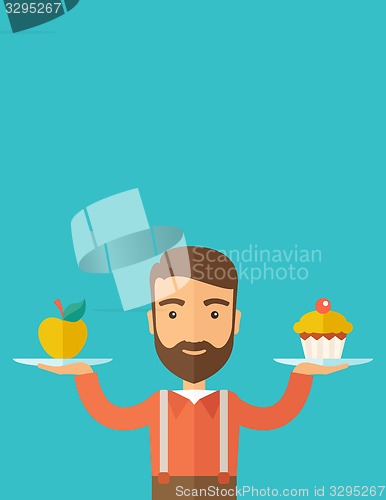 Image of Man carries with his two hands cupcake and apple.