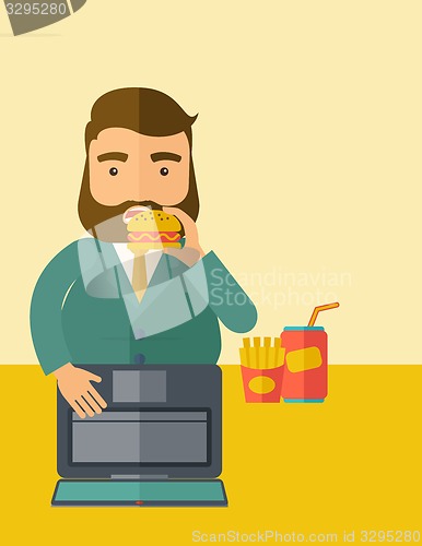 Image of Young fat guy eating while at work.