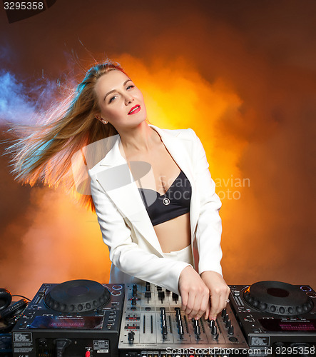 Image of Beautiful blonde DJ girl on decks - the party,