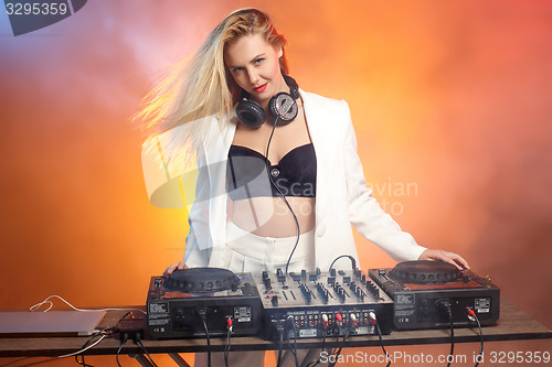 Image of Beautiful blonde DJ girl on decks - the party,